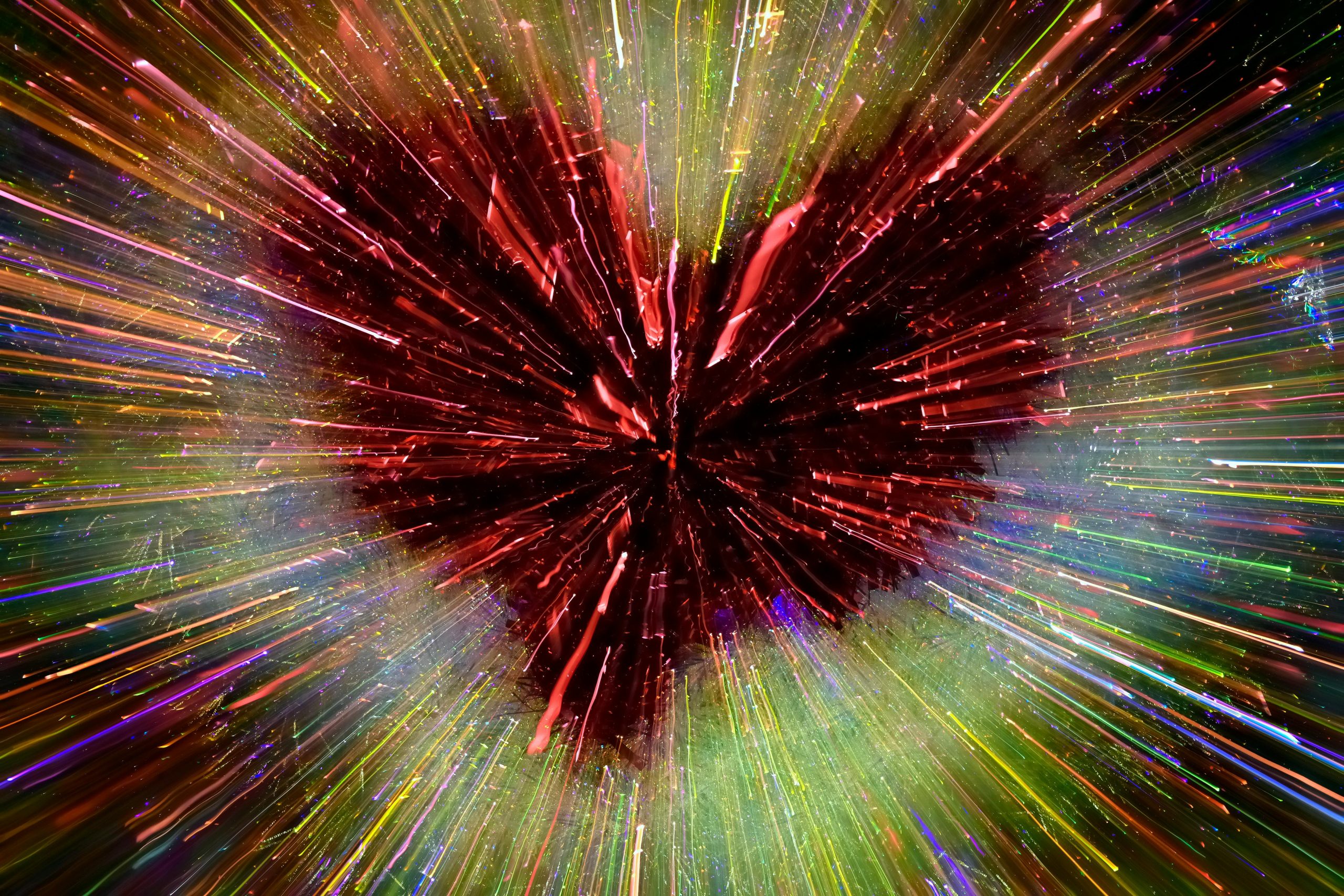Abstract heart exploding with colorful light rays, symbolizing love and energy.